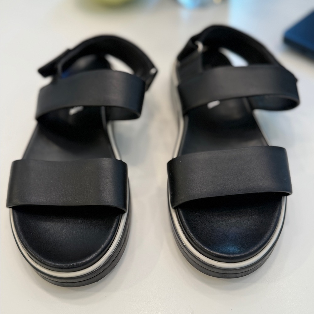 Prada Logo Embossed Rubber Trimmed Leather Sandals in Black